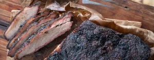 Sliced smoked brisket on a table. Texas Style Barbecue